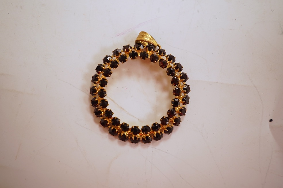 Two necklaces, comprising: a three-strand cultured pearl necklace, to a cabochon garnet and diamond clasp, length 34cm; and a paste and gilt metal pendant on a gold chain, chain length 44cm, stamped 14K, gross weight of
